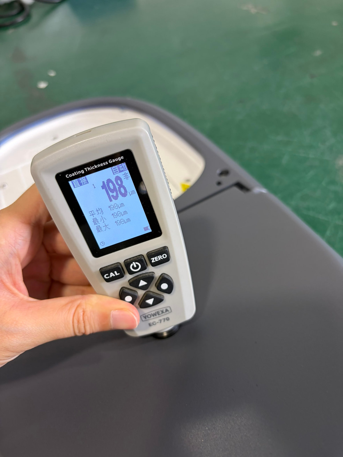 LUXIFIC Square II street luminaire coating thickness inspection using a YOWEXA EC-770 gauge showing a current reading of 198um