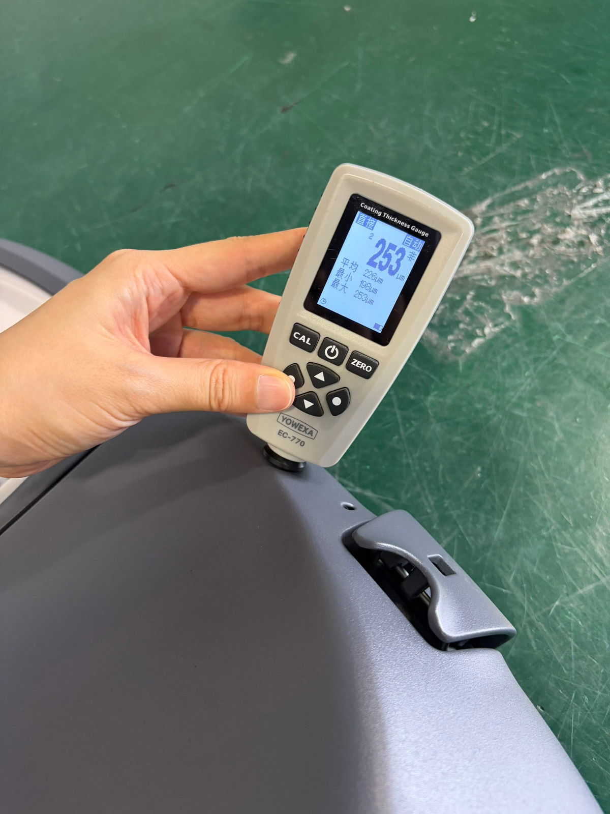 LUXIFIC Square II street luminaire coating thickness inspection using a YOWEXA EC-770 gauge showing a current reading of 253um