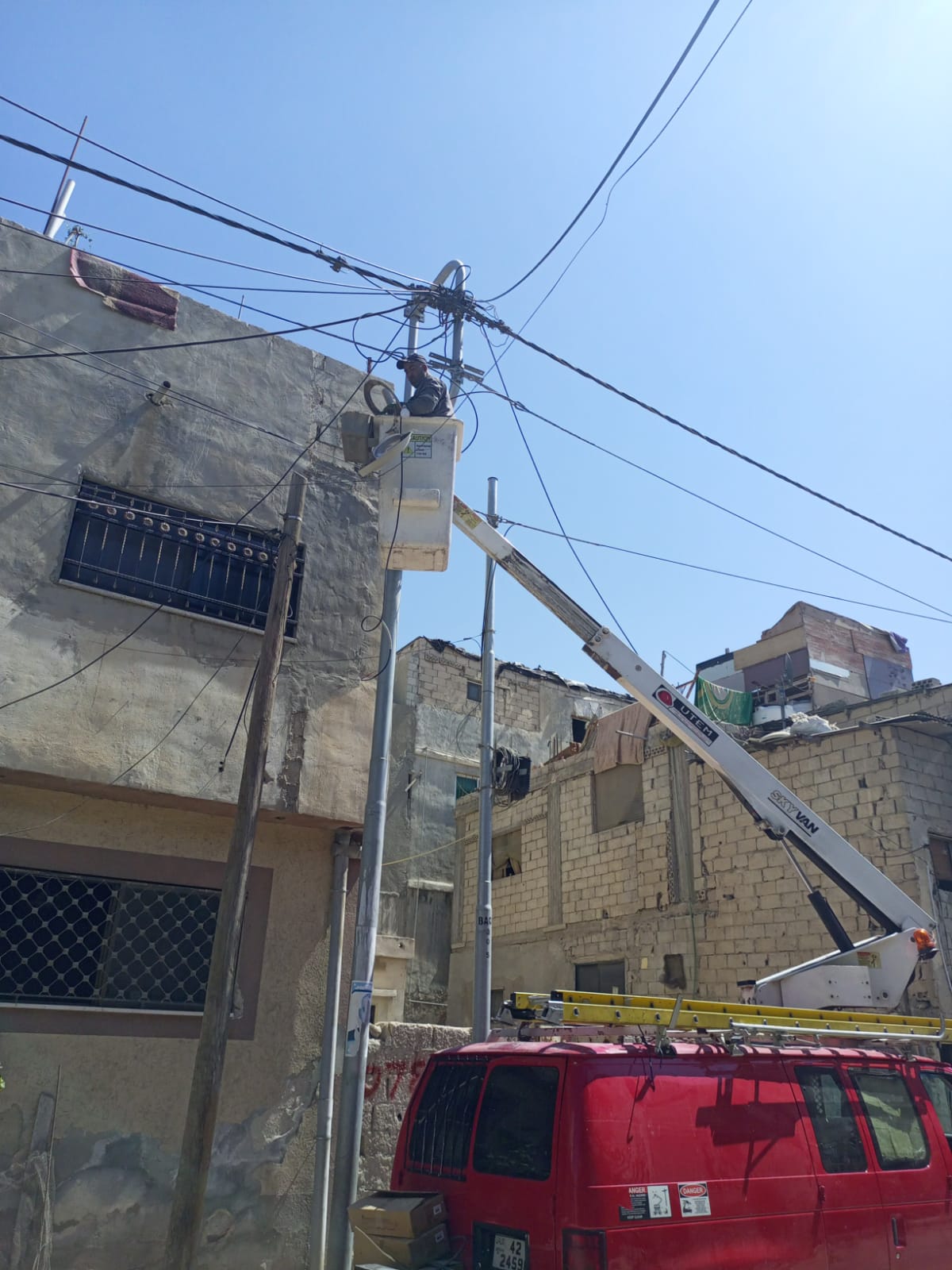 Aerial work platform and installation team replacing a roadway luminaire in Asia