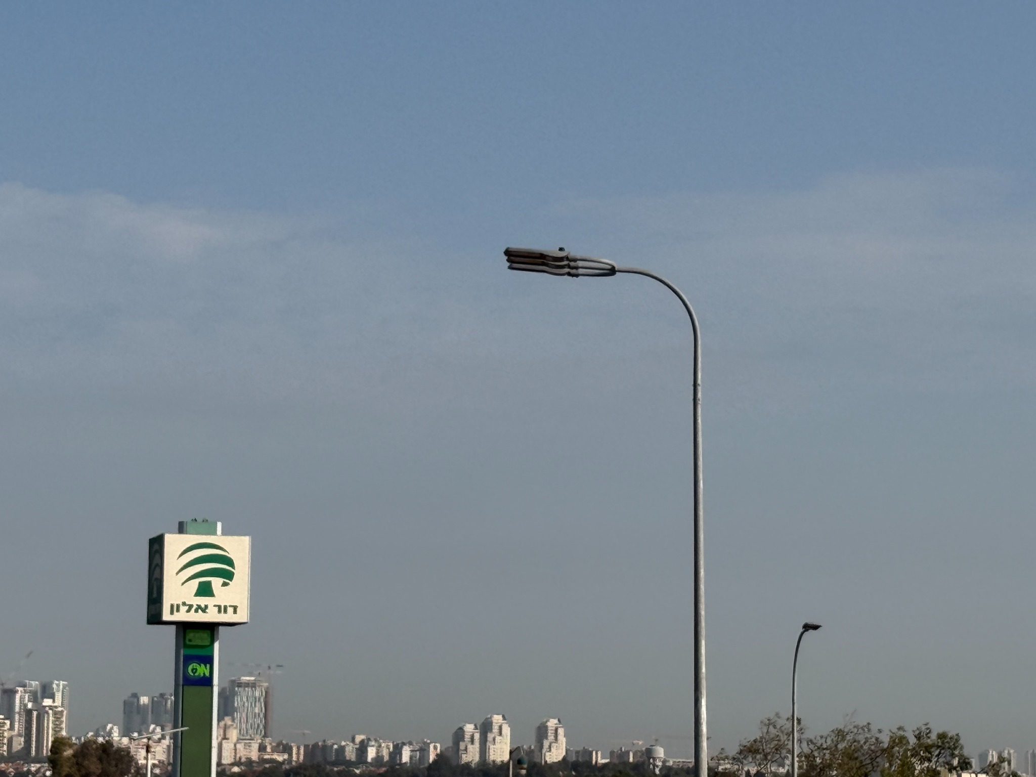 Installed LED road luminaire on a curved roadside lighting pole in the Middle East